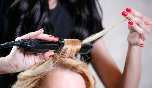 istock Making curls with iron at the hairdresser's 1481363342