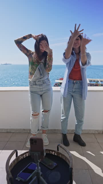 Mother and daughter dancing on a balcony for social media