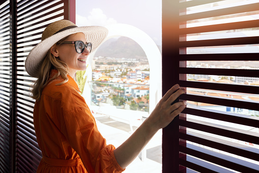 woman standing in rooftop penthouse terrace shutter doors and enjoy the view over the city
