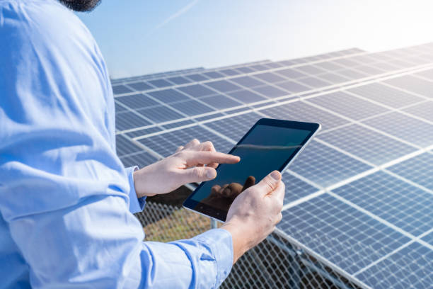 istock Engineer with a tablet with photovoltaic solar panel system plant. 1481365761