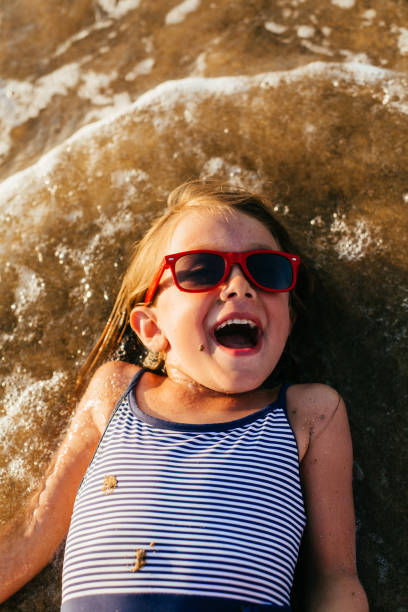 istock Little girl having fun on the beach 1481366045