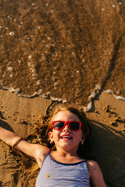 istock Little girl having fun on the beach 1481366102