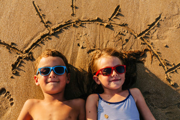 istock Children lying in the sand and having summer fun 1481366147