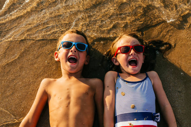 istock Children lying in the sand and having summer fun 1481366204