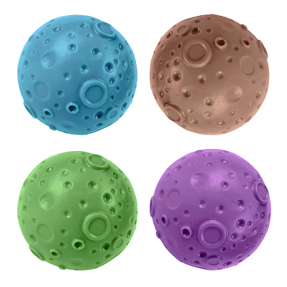 Here are four rubber balls shaped as planet with craters isolated on white background.