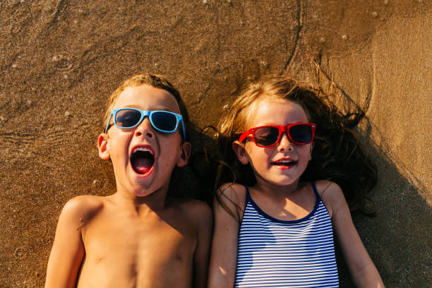 istock Children lying in the sand and having summer fun 1481366241