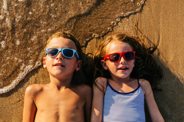 istock Children lying in the sand and having summer fun 1481366248