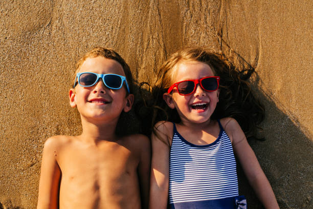 istock Children lying in the sand and having summer fun 1481366263
