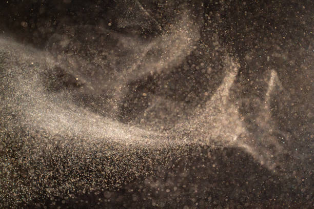 istock Organic dust particles floating on a light beam on black background. 1481367647