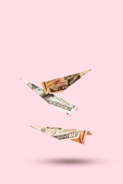 istock Three airplanes making of dollar money flying on pink background 1481368420