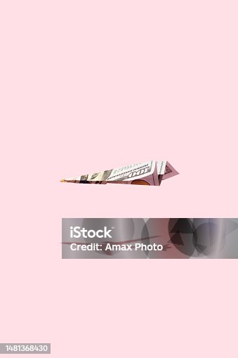 istock Airplane making of dollar money flying on pink background 1481368430