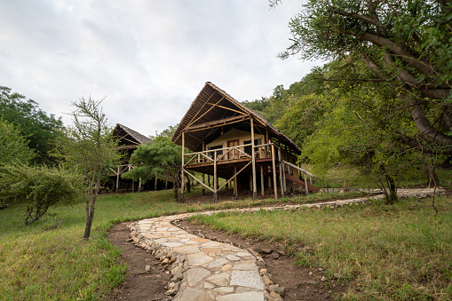 Tarangire National Park, Tanzania, Africa - March 14, 2023: View of a tent cabin on stilts for guests at the Sangaiwe Tented Lodge tented cabins
