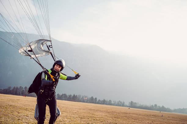 istock Skydiving woman touches the ground 1481370694