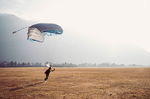 Skydiving woman touches the ground