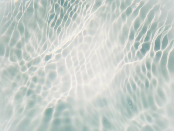 istock Defocus blurred transparent blue colored clear calm water surface texture with splashes and bubbles. Trendy abstract nature background. Water waves in sunlight with copy space. Blue water shine 1481372512