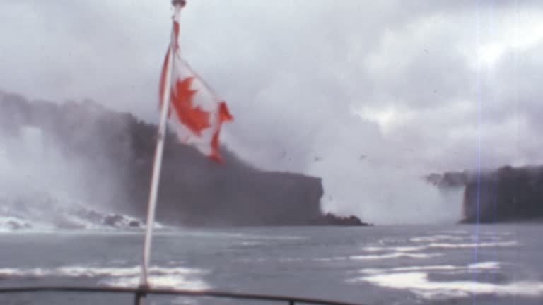 Flag of Canada Waving in Wind. Red Marple Leaf with Niagara Falls Background