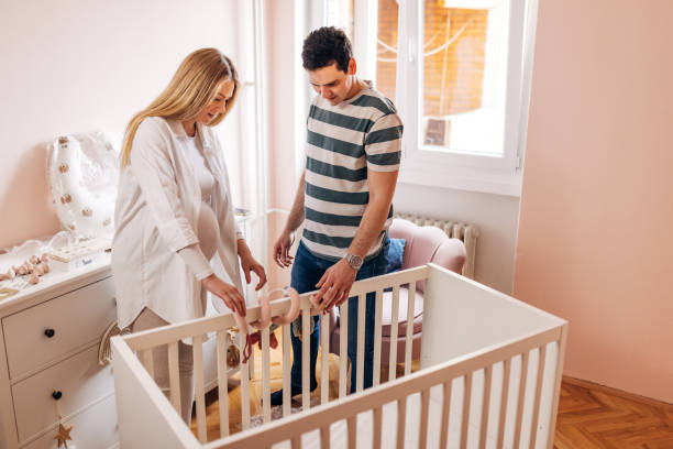 istock Happy future parents are preparing the baby's room for the baby's arrival 1481373234