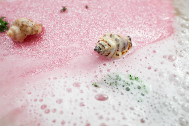 istock White foam, water and pink glitter with sea shells 1481374381