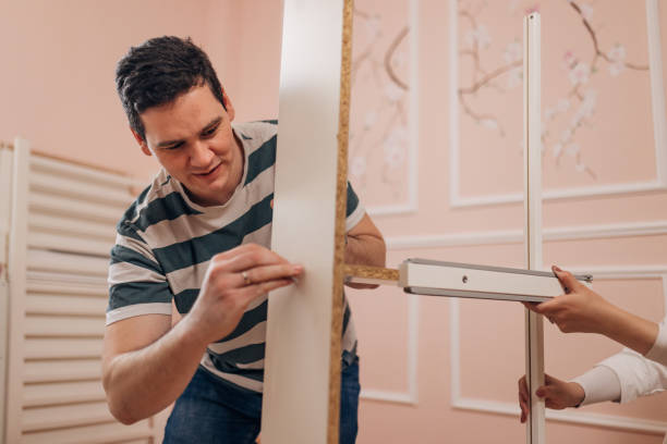 istock A man focuses while assembling a crib for a baby 1481374740