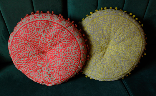 red and yellow circular decorative pillows