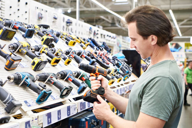 Electric screwdriver in hand man in shop stock photo