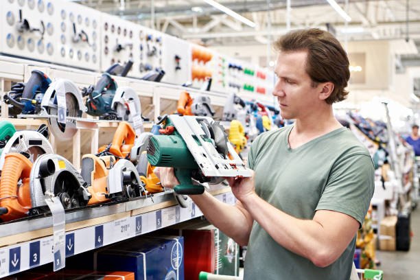 istock Man chooses electric saws in store 1481375156