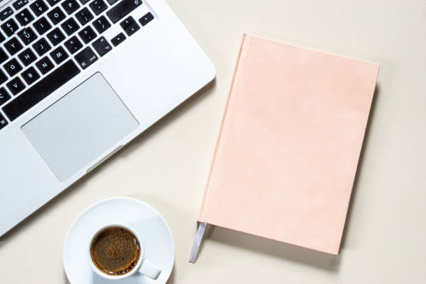 istock bright feminine banner or header with a coffee, stylish workspace with laptop computer, modern office accessories and a small notebook on a blush table, top view, flat lay 1481376946