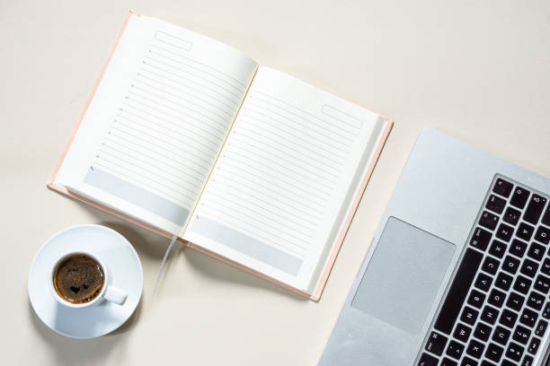 istock bright feminine banner or header with a coffee, stylish workspace with laptop computer, modern office accessories and a small notebook on a blush table, top view, flat lay 1481376947