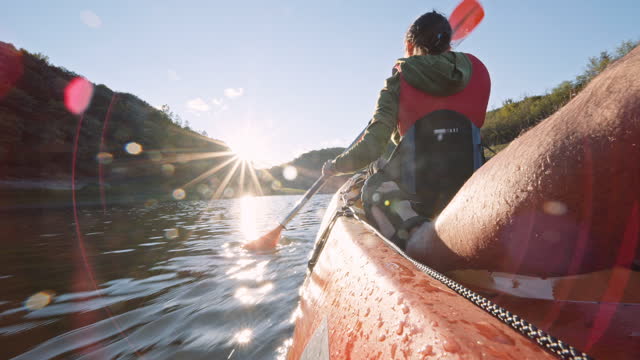 Kayaking and eco tourism. Couple paddling in lake.