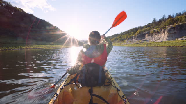 Kayaking and eco tourism. Couple paddling in lake.