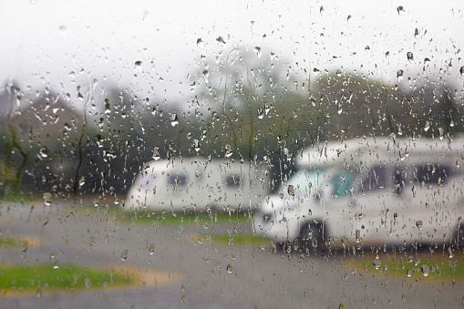 Rainy days and holidays- view from out of a caravan on a wet cold day, looking over over caravans and camper vans, a typical British holiday vacation weather, rain