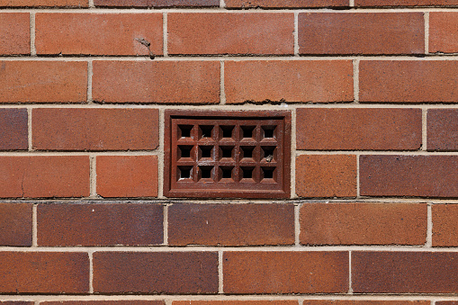Air vent in an old brick wall.