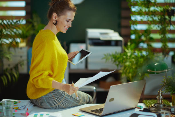istock business owner woman in green office working with documents 1481382373
