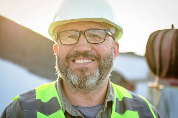 portrait of a handsome worker in a hard hat stock photo