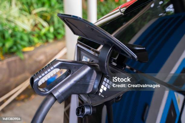 black-electric-vehicle-with-socket-plugin-charger-stock-photo