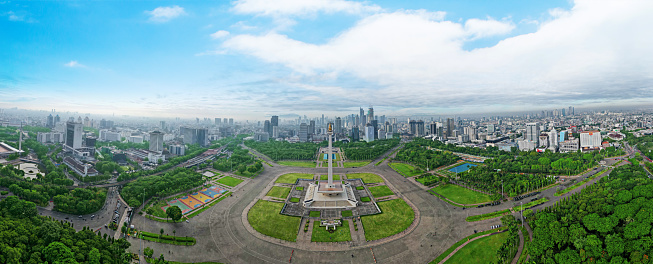 JAKARTA - Indonesia. November 07, 2022: Beautiful panoramic view of National Monument with Jakarta cityscape at misty morning