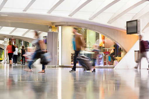 People walking down modern hallway, blurred motion, Liege,-Guillemins, Belgium.