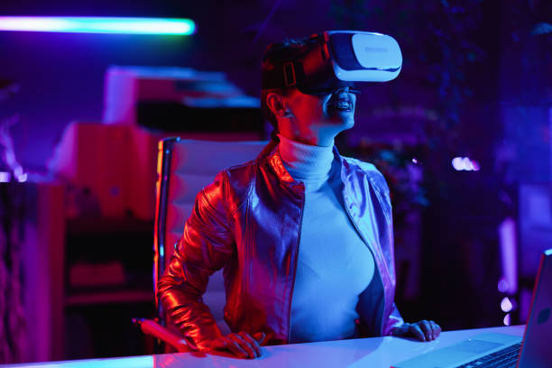 istock smiling woman in virtual reality goggles in office 1481387457