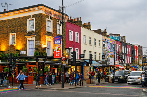 Camden Town, London, UK: Camden High Street in the early evening with colorful buildings and people.