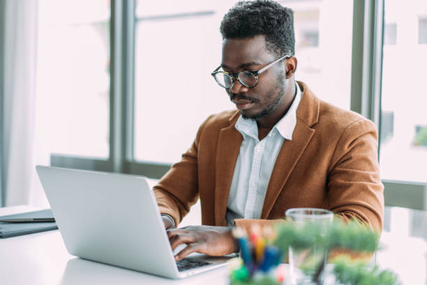 istock Successful businessman in modern office working on laptop. 1481389553