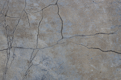 old concrete construction surface with age and cracks all over