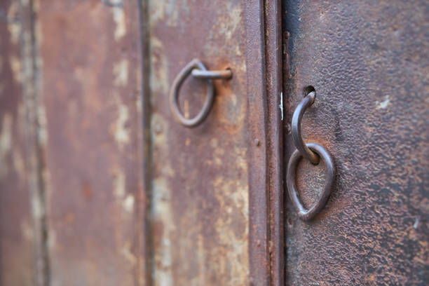 close-up locking rings on an old metal rusty door panel