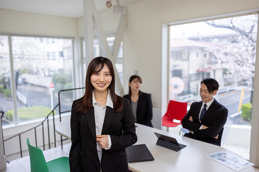 Portrait of young leader standing in meeting room