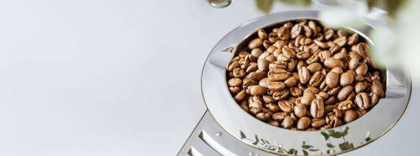 istock Coffee banner with natural roasted coffee beans in bean hopper with copy space 1481394634