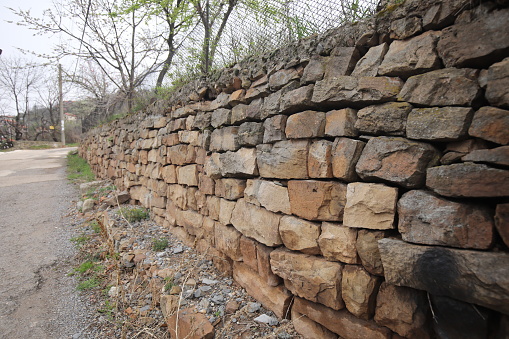 Traditional old dry stone wall constructed without mortar or cement