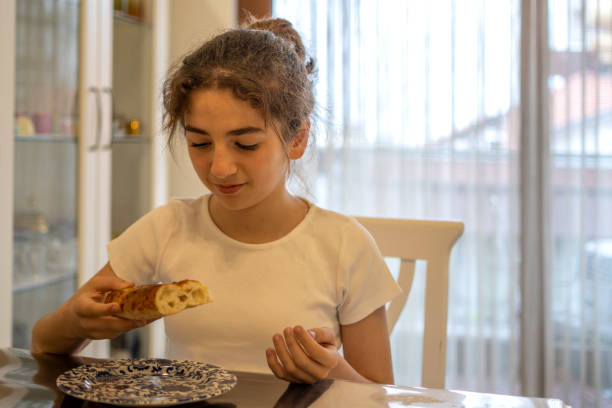 Beautiful girl tasting bread