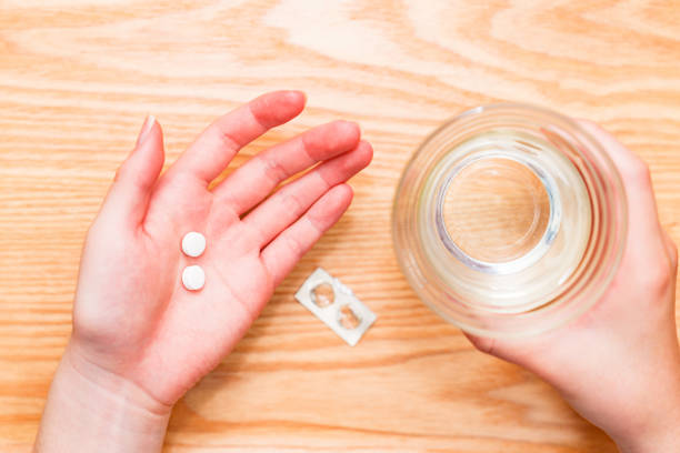 istock person taking some tablet medicine 1481397450