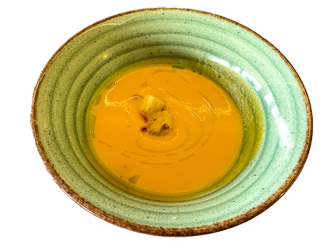 Bowl of sweet pumpkin soup - white background