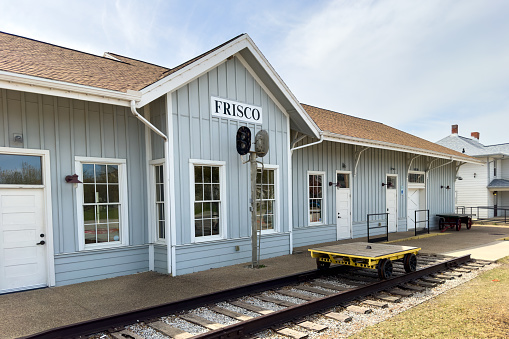 Frisco, Texas, USA - April 10, 2023. Frisco train station entrance, museum exhibition, trolley on platform, retro transportation