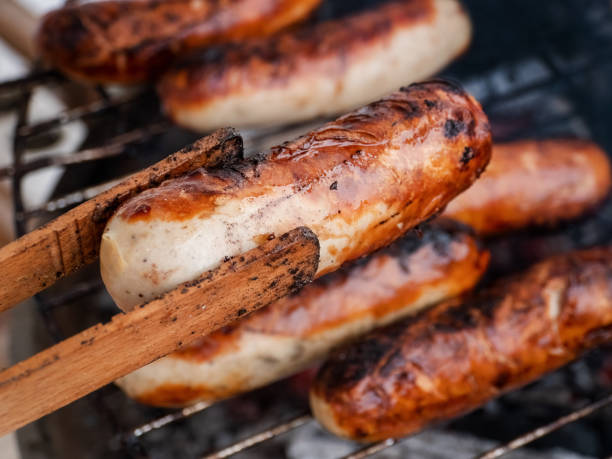 istock Original German Bratwurst sausage sizzling on the grill 1481399540